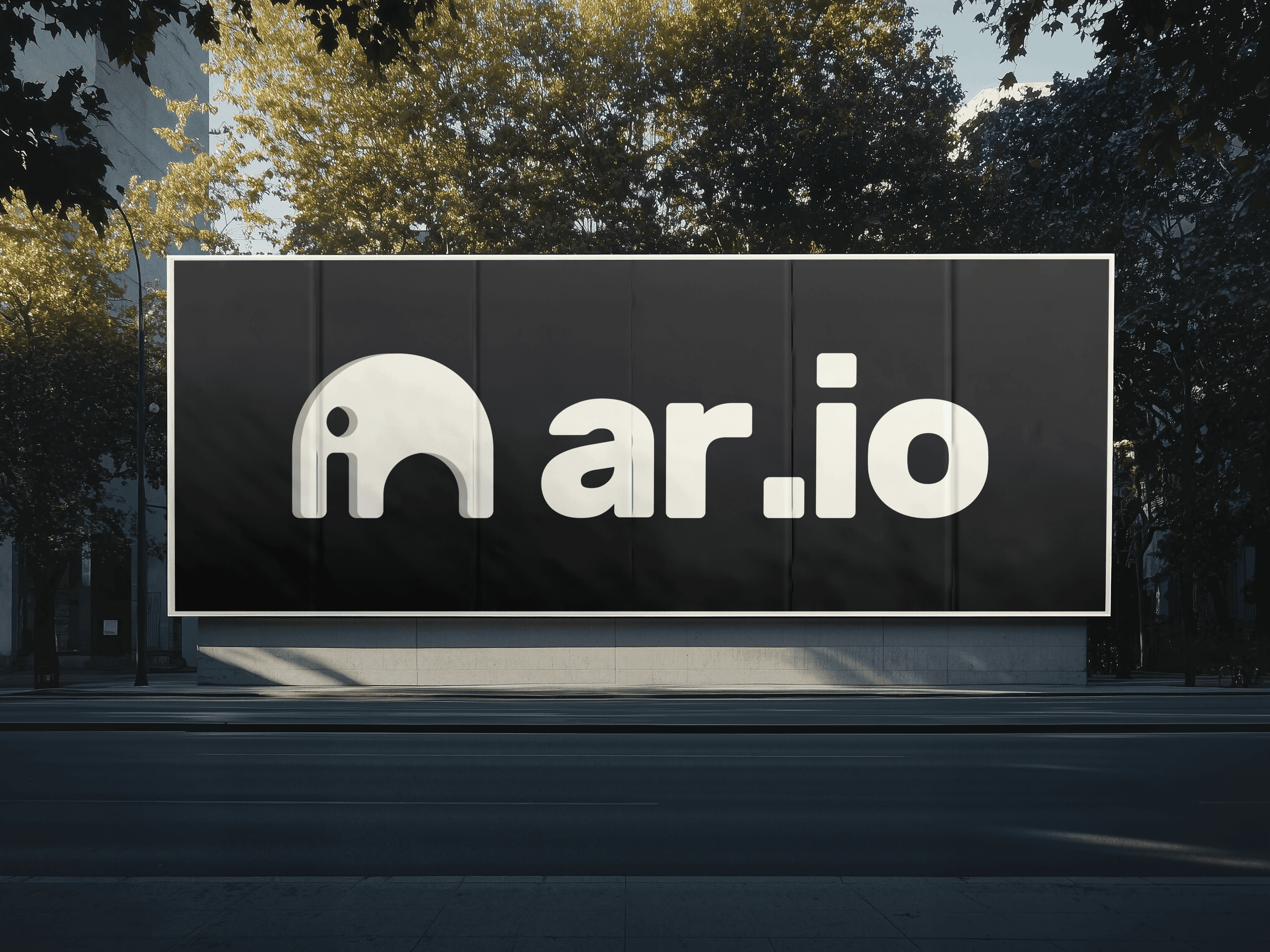 AR.IO street billboard — the wordmark on a black city wall